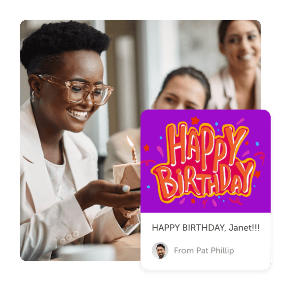 Woman smiling holding cake and "happy birthday" post from a group greeting card by Kudoboard